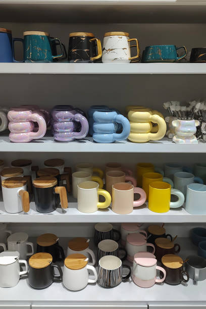 istock Stack of color ceramic cups on market shelf. 2198870859