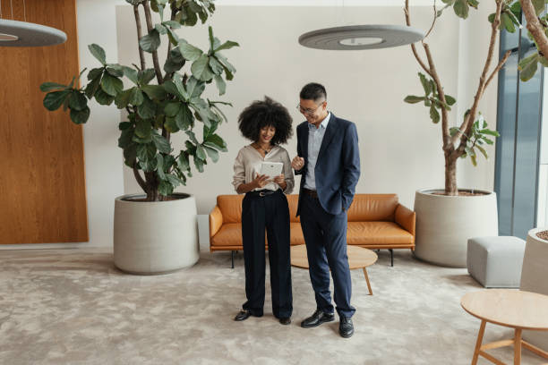 istock Businessman collaborates with a colleague on tablet 2198871977