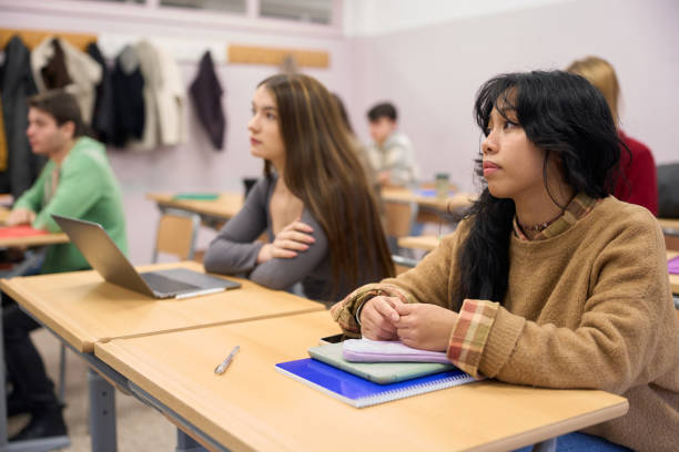 istock High school students listening attentively in class 2198873169