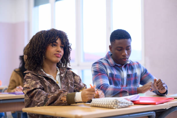 istock High school students listening attentively in class 2198873678