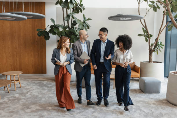 istock Group of Professionals Walking Together in Office 2198874612