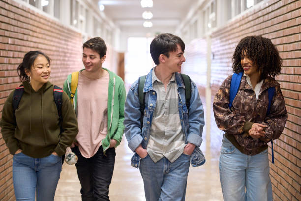 istock High school students walking and talking in school hallway 2198874826