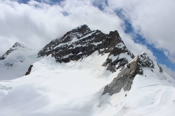 istock Snowy mountain peaks under a cloudy sky. 2198875305
