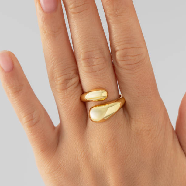istock Elegant gold ring on a woman's hand on a white background. jewelry. 2198876421
