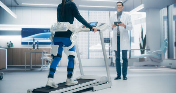 istock Woman Wearing Headset for Advanced Physical Rehabilitation Using an Exoskeleton on a Treadmill in a Futuristic Medical Lab, Showcasing Advanced Technology and Innovative Recovery Techniques 2198877373