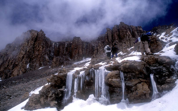 Climbers ascend the outer wall of Kibo crater en route to the summit of Mt. Kilimanjaro in Tanzania, Africa. stock photo
