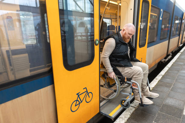 A wheelchair bound commuter exiting the train on a day trip in the Netherlands
