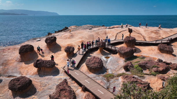 istock Visitors exploring unique rock formations at Yehliu Geopark during a clear day in Taiwan 2198884092