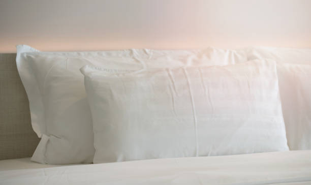 istock pillows on bed in hotel room 2198884110