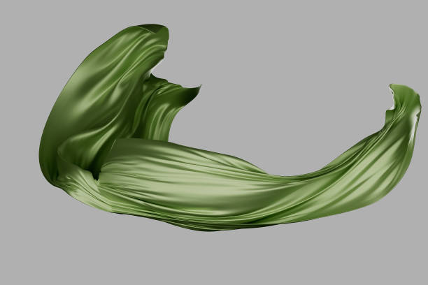 A green fabric is blowing in the wind. The fabric is long and flowing, creating a sense of movement and freedom. The color green is often associated with nature and growth