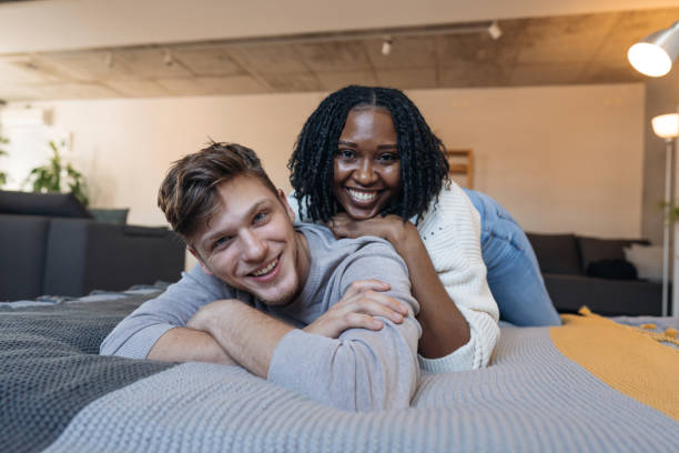 istock Happy multi-ethnic couple relaxing on bed at home 2198885107