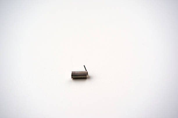 istock Close-up of metal coil spring against white background. 2198886171