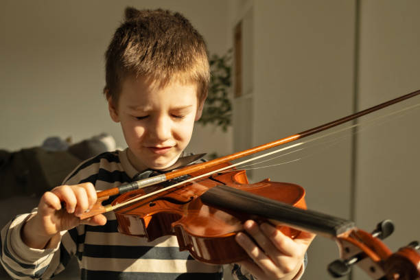 istock Little boy and a violin 2198888860