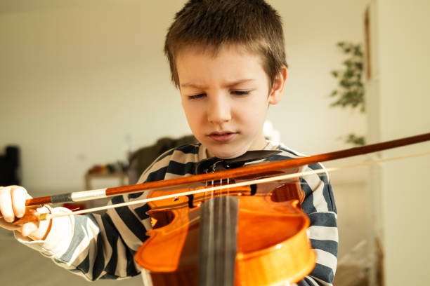 istock Little boy and a violin 2198888864