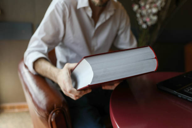 Young student sitting in a caffe, drinking coffee, taking a notes and preparing for the seminar. Education, lifestyle concept