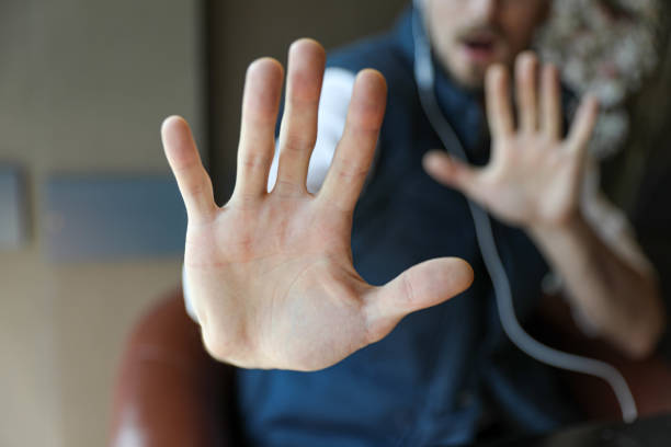Young Hacker Looking at the Camera and Showing Numbers with His Fingers