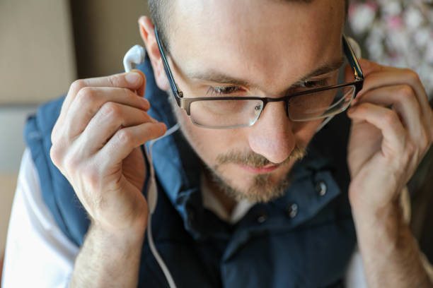 Asian man listening to music with headphones