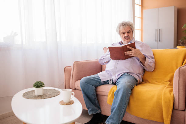 istock Senior man reading at home 2198891511