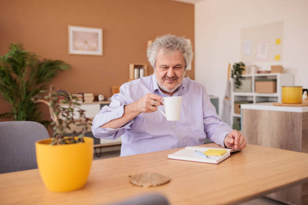 istock Senior man working with paperwork at home 2198892570
