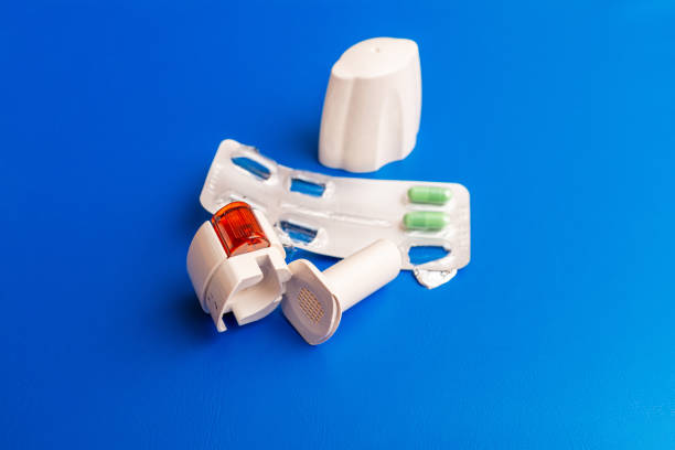 istock COPD or Asthma medication instruments a capsule Inhaler on blue background. Inhaler or bronchodilator and medical powder capsules for prevention and treatment of bronchitis or asthma. 2198894686