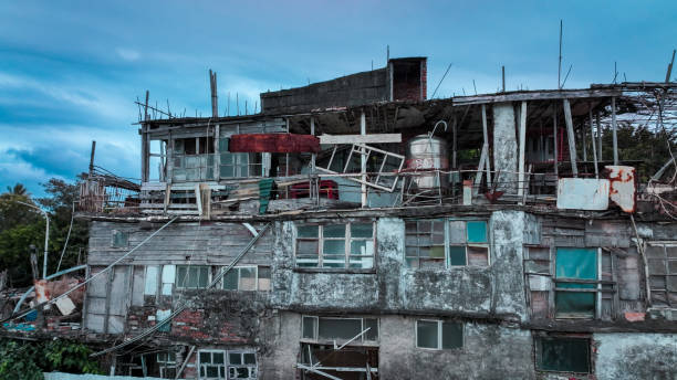 An abandoned building in Taitung showcases its dilapidated structure against a cloudy evening sky, highlighting neglect.