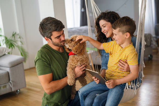 istock Parents with kid having fun online with application watching video cartoon or playing game on tablet 2198896262