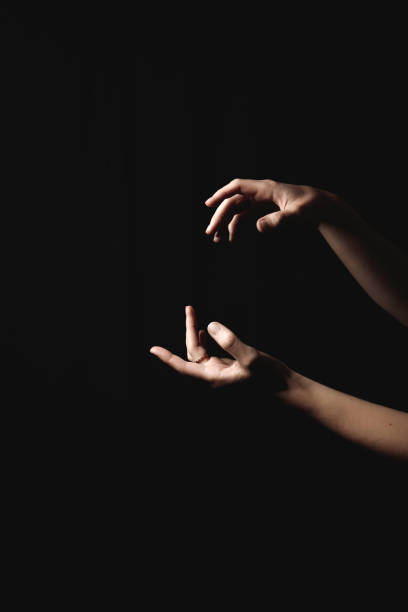 istock Elegant hands intertwining against deep shadows, conveying romantic connection and mysterious emotional depth for valentine themes book cover copy space 2198897909