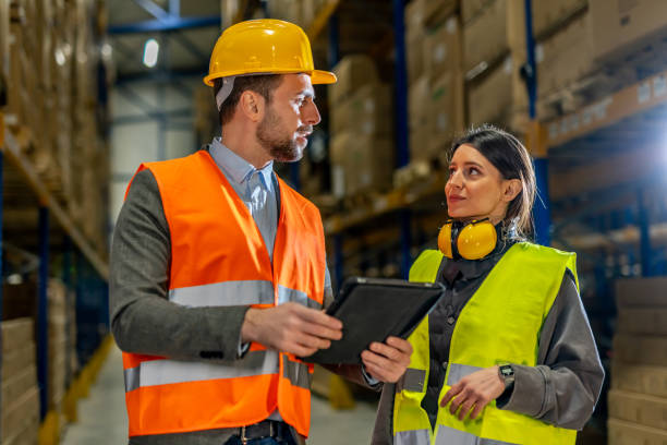 istock Warehouse Managers Reviewing Plans Using a Tablet and Communication Equipment 2198899273