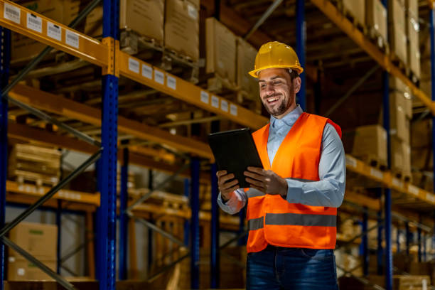 istock Warehouse Worker in Safety Gear Using Tablet for Inventory Management 2198899492