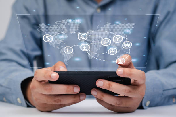 istock A person interacts with a smartphone displaying a digital world map and social network icons, symbolizing global connectivity. 2198899891