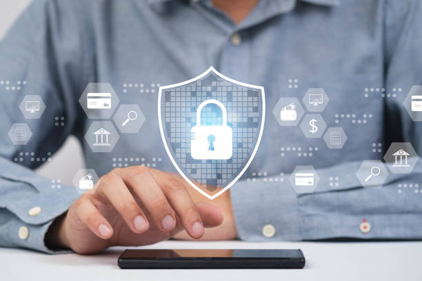 istock A person secures data using a smartphone with digital security icons and a shield symbol, representing cybersecurity and protection. 2198899926