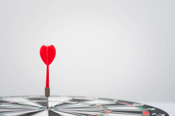 istock A red dart securely embedded in the center of a dartboard, symbolizing precision, focus, and achievement in a minimalist setting. 2198899939