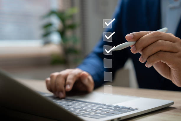 istock Checklist performance monitoring concept,Businessman using pen tick checkbox for quality control checklist,Approving business project documents in online application.Online survey,Filling digital form 2198903009
