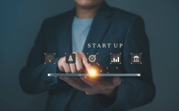 istock A professional holding a tablet with icons symbolizing startup concepts, innovation, and business growth illuminated by a glowing effect. 2198904904
