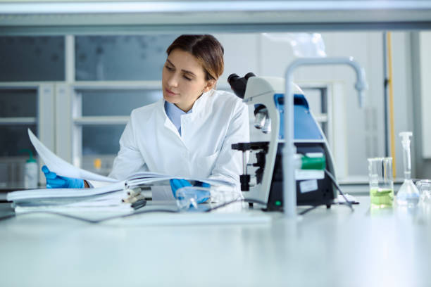 istock Female chemist working on medical documents in laboratory. 2198905756