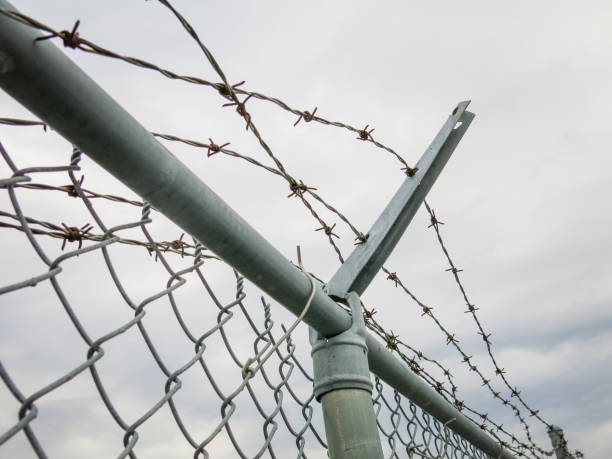 istock Barbed Wire Metal Security Prison Fence 2198906591