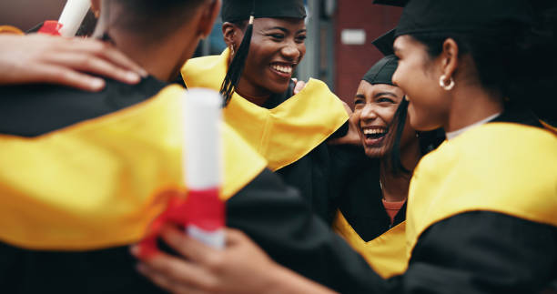 istock Celebration, education and graduation with friends hugging on college or university campus together. School, smile and success with happy graduate or student people cheering for milestone goals 2198907826