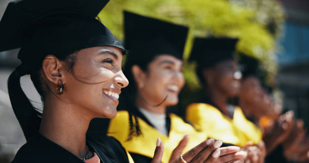 istock Woman, students and applause at university for graduation, peer support and happy for achievement. People, clapping and outdoor on campus for academic success, pride and smile for education milestone 2198907835