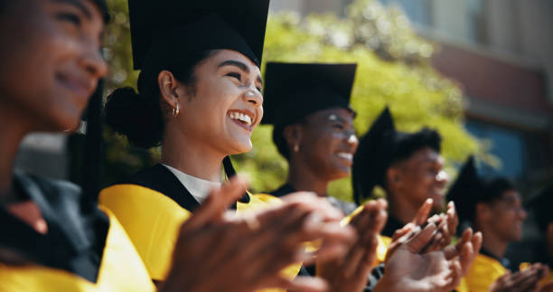 istock Students, happy and applause at university for graduation, peer support or cheering for achievement. People, clapping or outdoor on campus for academic success, pride or smile for education milestone 2198907845