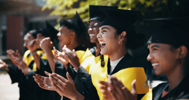 istock Students, excited and applause at university for graduation, peer support and happy for achievement. People, clapping or outdoor on campus for academic success, pride or cheer for education milestone 2198907847