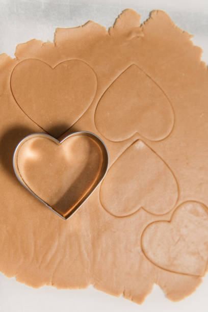istock Rolled Out Cookie Dough Being Cut into Hearts 2198909031