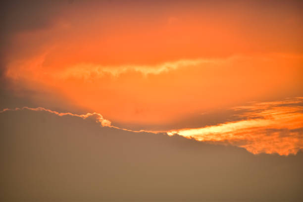 Dramatic colorful cloudscape with the sunbeam at the sunset. Sunlight through the clouds. Sunset skyscape, sunset background. Nature concept