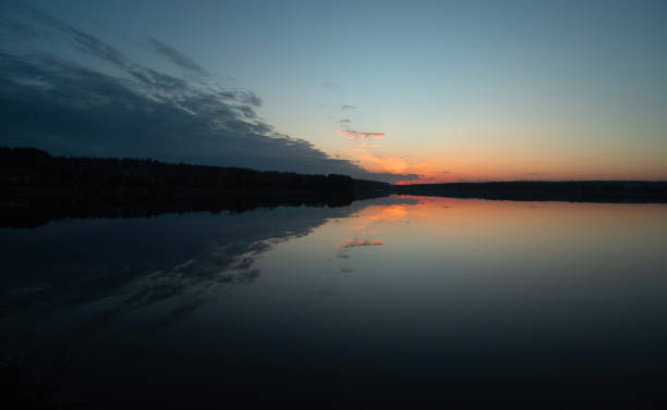 istock Beautiful sunset on the lake with a reflection on the water surface. 2198909335