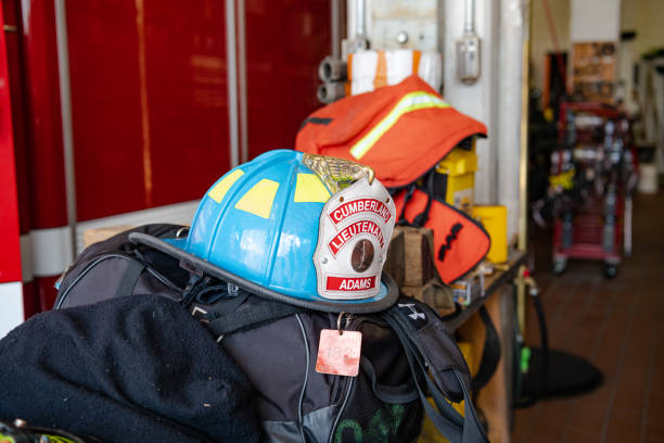 CUMBERLAND, Maryland, USA. July 14, 2024 Firemans helmet lies by fire engine in fire station