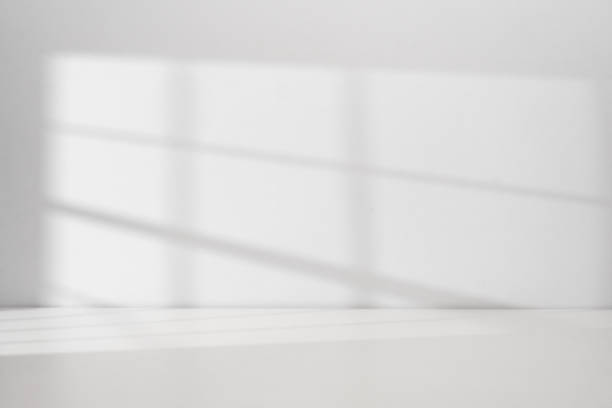istock Sunlight coming through the window on the white wall 2198910560