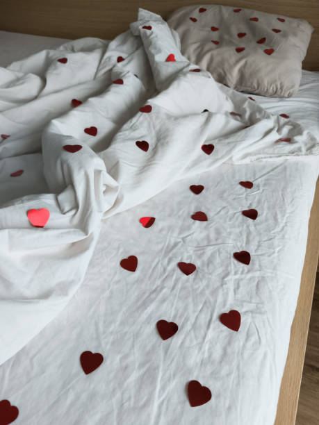 istock Soft bedding featuring red heart decor, setting intimate mood for romantic morning celebration with partner 2198910641