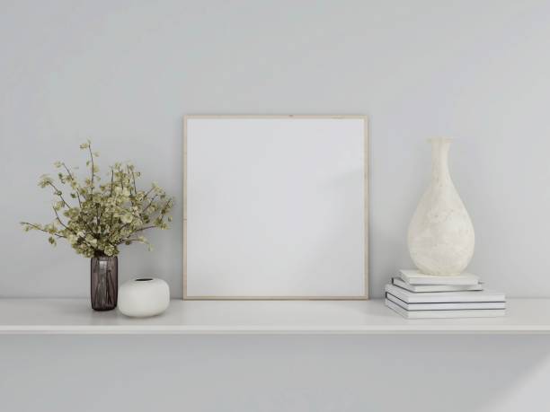 istock Blank square frame mockup with books, plant and table decorations 2198911617