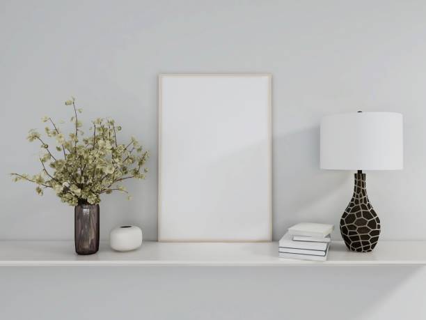 istock Blank vertical frame mockup with table lamp, books and ornamental plants 2198911619