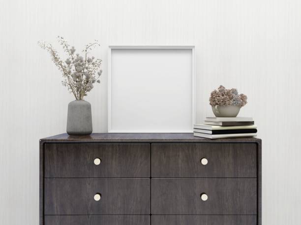 A simple living room showcasing a sideboard cabinet, ceramic tile flooring, and a white wall background.