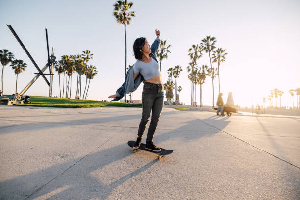 istock Happy sunset skating by the beach 2198911840